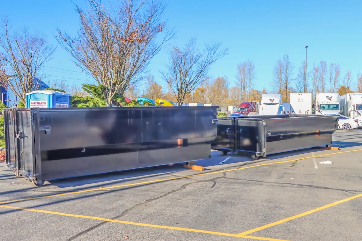 Professional dumpster rental service with roll-off container on residential driveway in Mount Airy